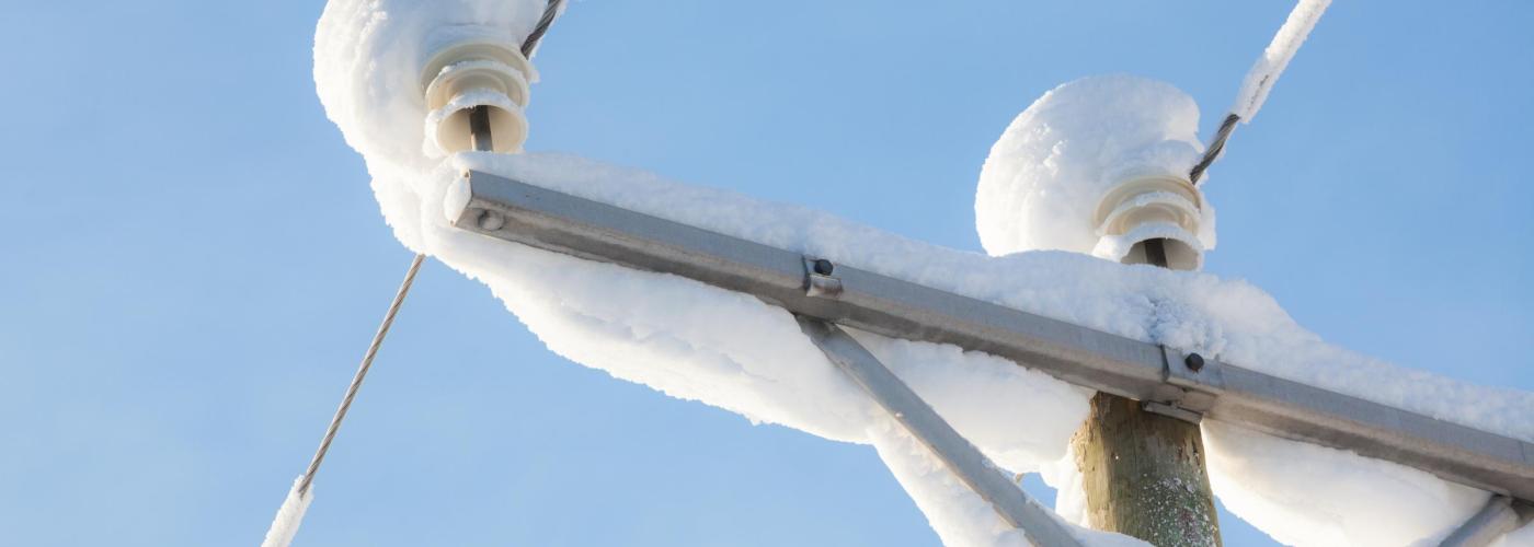 Power pole with snow on it. 