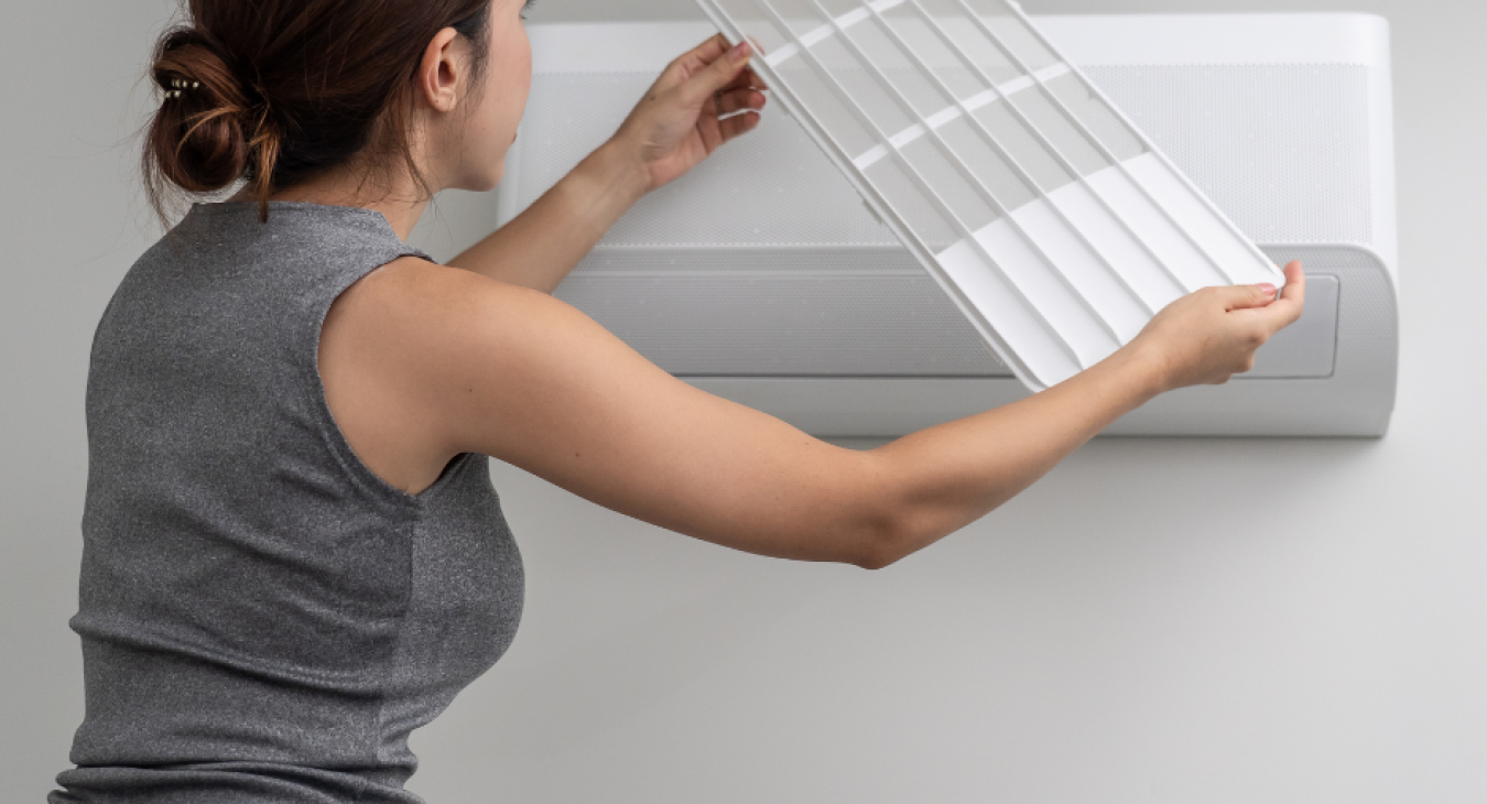 woman checking hvac filter